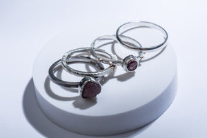 Set of four silver rings with gold details & tourmaline stone