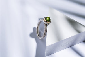 Silver ring with gold details & peridot stone