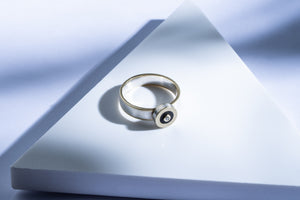 Silver ring with gold details, ebony and white diamond